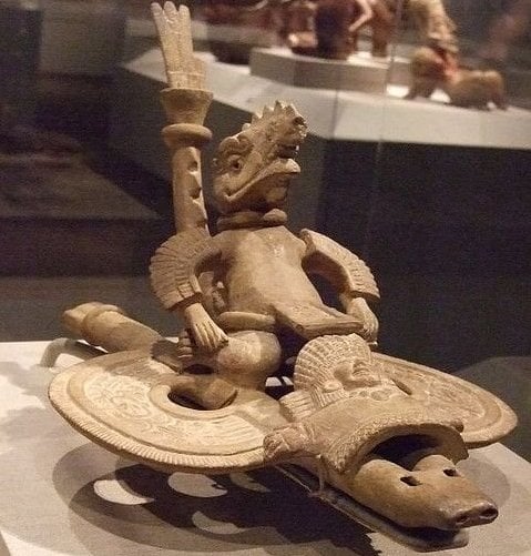 Ancient reptilian riding a vehicle