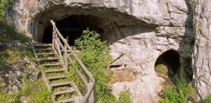 The entrance to Denisova Cave in Siberia, where evidence of a mysterious branch of the human tree was discovered. Credit Bence Viola