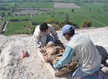 Jorge Achka Rodriguez (Universidad Nacional Mayor de San Marcos, Lima) and Manuel Angel Mamaní (Universidad Nacional de San Agustín, Arequipa) excavating a looted mummy bundle at Uraca(Photo courtesy of Beth K. Scaffidi)