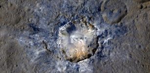 Ceres' Haulani Crater, with a diameter of 21 miles (34 kilometers), shows evidence of landslides from its crater rim. Smooth material and a central ridge stand out on its floor. This image was made using data from NASA's Dawn spacecraft when it was in its high-altitude mapping orbit, at a distance of 915 miles (1,470 kilometers) from Ceres. Credits: NASA