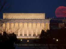 The full moon is seen as it rises near the Lincoln Memorial, Saturday, March 19, 2011, in Washington