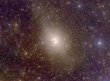 Centaurus A, an elliptical galaxy 13 million light-years from Earth, hosts a group of dwarf satellite galaxies co-rotating in a narrow disk, a distribution not predicted by dark-matter-influenced cosmological models. Credit: Christian Wolf and the SkyMapper team / Australian National University