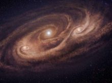 Artistic impression of the monster galaxy COSMOS-AzTEC-1. This galaxy is located 12.4 billion light-years away and is forming stars 1,000 times more rapidly than our Milky Way galaxy. ALMA observations revealed dense gas concentrations in the disk, and intense star formation in those concentrations. Credit: National Astronomical Observatory of Japan