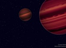 Artist's conception of the Epsilon Indi system. The two brown dwarfs orbit their common center of mass, which in turn orbits the much more distant primary component, a Sun-like star. By mapping the orbital motion of the brown dwarfs, the team was able to determine their masses. Much like our Solar System's giant planets, brown dwarfs are thought to have cloud belts that encircle the entire object and give it a striped appearance. Illustration is by Roberto Molar Candanosa and Sergio Dieterich, courtesy of the Carnegie Institution for Science.