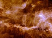 The Taurus Molecular Cloud, pictured here by ESA's Herschel Space Observatory, is a star-forming region about 450 light-years away. The image frame covers roughly 14 by 16 light-years and shows the glow of cosmic dust in the interstellar material that pervades the cloud, revealing an intricate pattern of filaments dotted with a few compact, bright cores — the seeds of future stars. (Image: ESA/Herschel/PACS, SPIRE/Gould Belt survey Key Programme/Palmeirim et al. 2013)