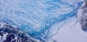 Cracks in the front of a glacier as it reaches the ocean. Credits: NASA/Adam Klein