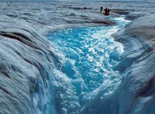 Meltwater stream flowing into a large moulin in the ablation zone (area below the equilibrium line) of the Greenland ice sheet. (Image courtesy Roger J. Braithwaite, The University of Manchester, UK via GISS)