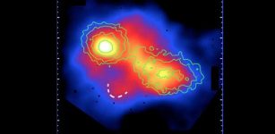 Image taken in the x-ray spectrum shows two galaxy clusters in the early stage of collision. The white dotted line shows the pre-merger shock. Image credit: RIKEN