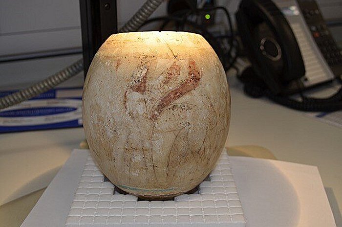 A decorated egg from the Isis Tomb, Vulci, Italy, under examination. Credit: (© Tamar Hodos, University of Bristol (with the permission of the Trustees of the British Museum)