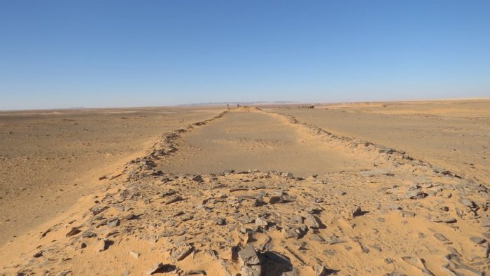 View along the length of a mustatil structure, note researchers at far end for scale, image shows character of these structures as two platforms connected by low walls. Credit: Dr. Huw Groucutt