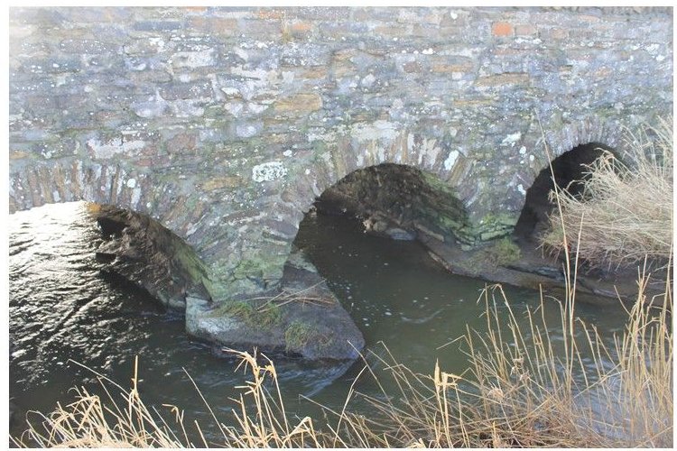 This is a bridge at the center of Dounby transect showing piers founded on bedrock. They found a stream channel cut into the bedrock. Credit: University of St. Andrews