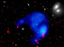 The orphan cloud is the blue umbrella-shaped part of this image, which is color-coded to show the X-ray part of the cloud in blue, the warm gas in red and the visible region in white. Images courtesy of European Space Agency / XMM-Newton