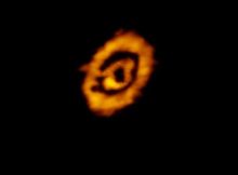 A false-color, submillimeter wavelength image of the protoplanetary disk around the star IM Lup showing dual rings of gas and dust. Astronomers for the first time have determined the vertical heights of both the dust and gas components in this and two other protostellar systems using multiwavelength datasets, finding that at large distances from the star they sometimes but not always have the same flaring profile. Credit: K. Oberg, CfA, et al.; ALMA (NRAO/ESO/NAOJ); B. Saxton (NRAO/AUI/NSF)