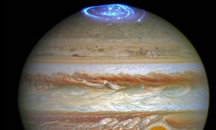 Composite image of two different Hubble observations. The aurorae were photographed during a series of Hubble Space Telescope Imaging Spectrograph far-ultraviolet-light observations taking place as NASA's Juno spacecraft approaches and enters into orbit around Jupiter. The full-colour disk of Jupiter in this image was separately photographed at a different time by Hubble's Outer Planet Atmospheres Legacy (OPAL) program, a long-term Hubble project that annually captures global maps of the outer planets. Credit: NASA, ESA, and J. Nichols (University of Leicester).