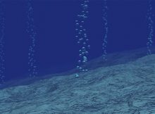 Methane gas bubbles rising from the ocean floor. Credit: Justin Kim