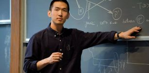 Zhoudunming Tu explains the science of exploring gluon distributions and deuteron breakup in ultra-peripheral collisions of deuterons and gold ions while speaking with a group of students at Princeton University. Credit: Yingshi Peng, Princeton