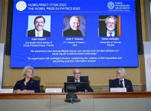 Secretary General of the Royal Swedish Academy of Sciences Hans Ellegren, centre, Eva Olsson, left and Thors Hans Hansson, members of the Nobel Committee for Physics announce the winner of the 2022 Nobel Prize in Physics, from left to right on the screen, Alain Aspect, John F. Clauser and Anton Zeilinger, during a press conference at the Royal Swedish Academy of Sciences, in Stockholm, Sweden, Tuesday, Oct. 4, 2022. Credit: Jonas Ekstromer /TT News Agency via AP