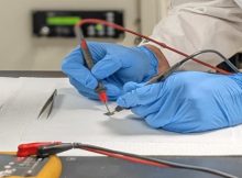 Furkan Turker, graduate student in the Department of Materials Sciences, works on a silicon carbide chip in the laboratory. Credit: Penn State