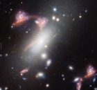 Webb Reveals Distorted Galaxy Forming Cosmic Question Mark