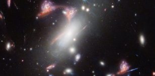 Webb Reveals Distorted Galaxy Forming Cosmic Question Mark